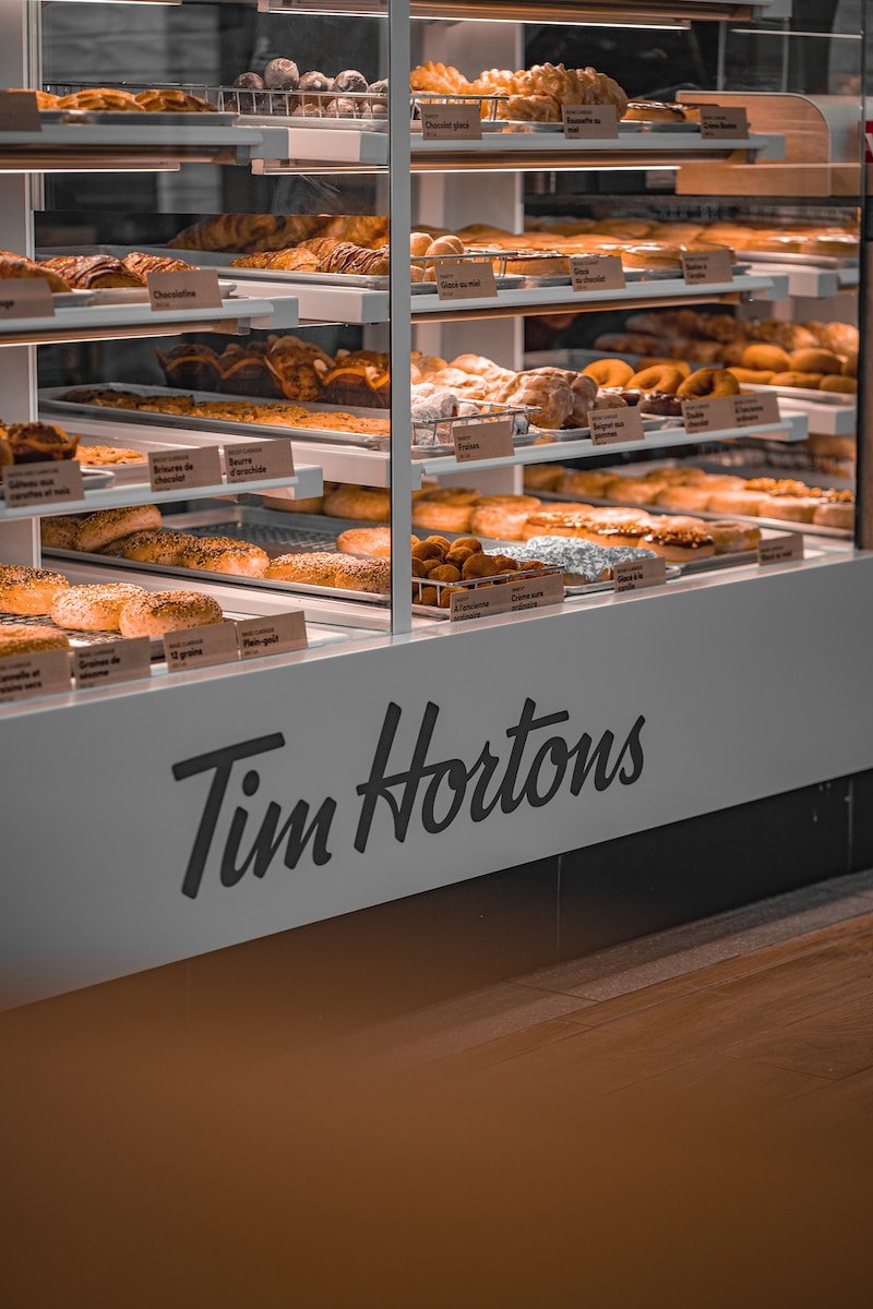 tim hortons display case filled with lots of donuts